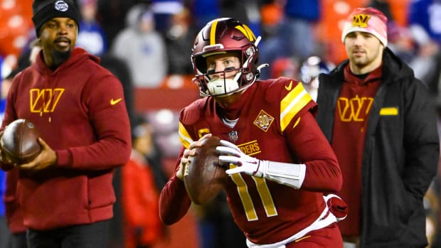 Washington Commanders quarterback Carson Wentz (11) warms up before the game against the New York Giants at FedExField.